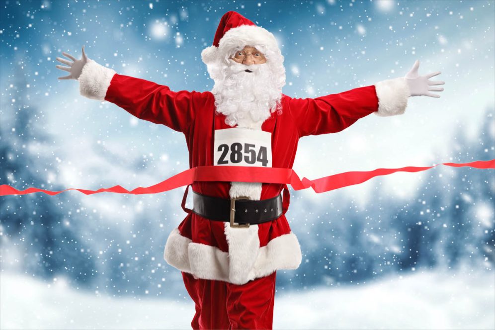 Full length portrait of Santa Claus on the finish line of a race isolated on white background